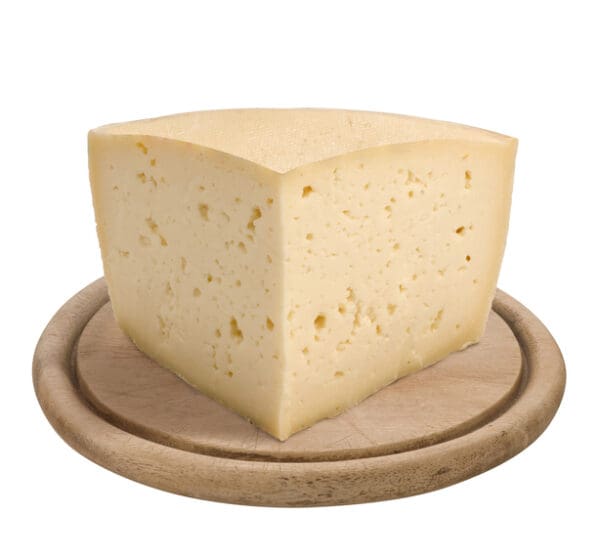 Montasio, italian cheese, on wooden plate, isolated